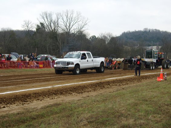 White 2007 Ford F-350 Super Duty pickup truck in a tractor pull event