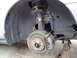 2003 Ford Taurus - Close-up view of a vehicle's front wheel hub and brake system, with the wheel removed.