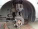 2003 Ford Taurus - Front wheel hub and brake assembly of a 2003 Ford Taurus, showing the suspension and brake components.