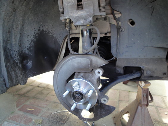 Front wheel hub assembly on jack stands, brake caliper visible