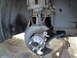 2003 Ford Taurus - New front wheel hub assembly installed on a vehicle supported by jack stands.