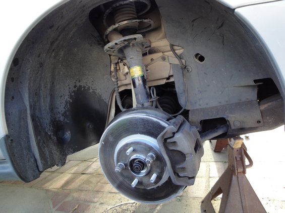 Front wheel hub, brake rotor, and caliper assembly on a jack stand