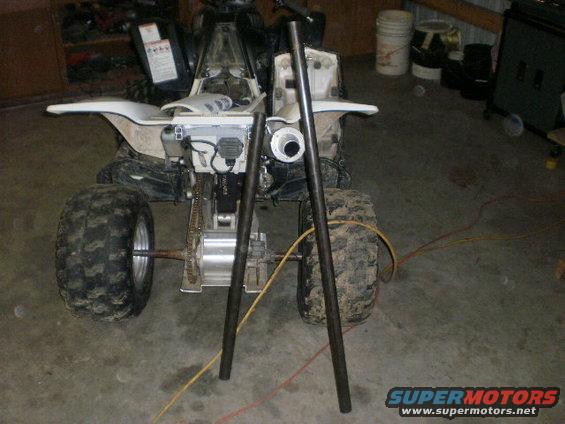 ATV rear end with two metal pipes in front of it