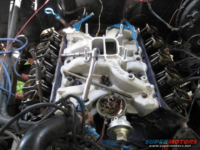 Installing the new intake carb and valve covers.