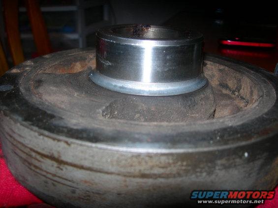 Close-up of a crankshaft pulley with a bearing pressed into it