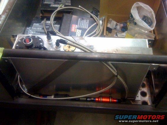Custom fuel tank with red fuel filter and braided lines