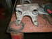 1995 Ford Bronco - A close-up view of a welded metal bracket, likely a vehicle part, on a workbench.