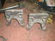 1995 Ford Bronco - Two custom-welded metal brackets are shown on a workbench, alongside various tools and equipment.