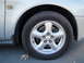 2003 Ford Taurus - Front wheel assembly of a silver 2003 Ford Taurus, a 24V DOHC badge.