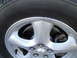 2003 Ford Taurus - A close-up view of a vehicle's wheel, tire, and brake assembly.