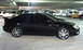 2008 Subaru Legacy - A black sedan with tinted windows and a rear spoiler is parked in a dimly lit garage.