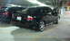 2008 Subaru Legacy - A black Subaru Legacy sedan is parked in a garage next to another vehicle.