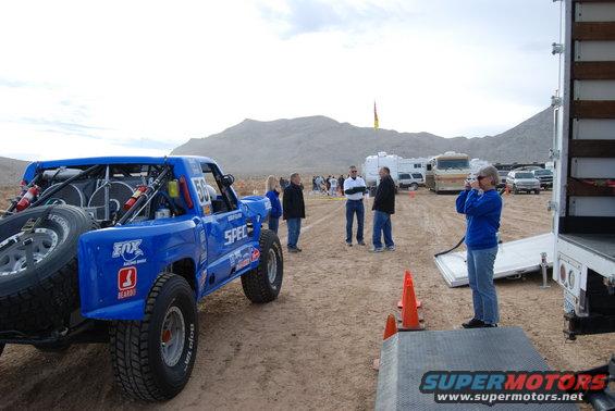 Blue off-road racing truck with spare tire, number 56, and Fox branding