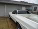 1973 Ford Ranchero - A white 1972 Ford Ranchero is parked next to a silver pickup truck in front of a residential garage.