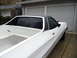 1973 Ford Ranchero - White 1973 Ford Ranchero with a black vinyl roof and diamond plate in the bed, seen from a 3/4 front angle.