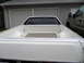 1973 Ford Ranchero - Rear view of a 1973 Ford Ranchero pickup truck bed, showing the white interior and a second vehicle parked nearby.