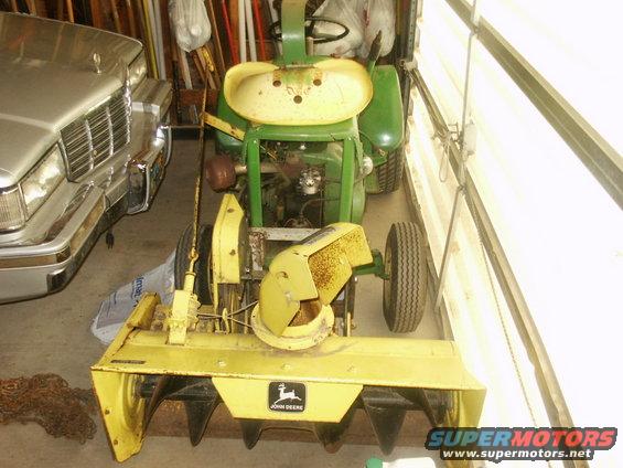 Yellow John Deere tractor with snow blower attachment, front view