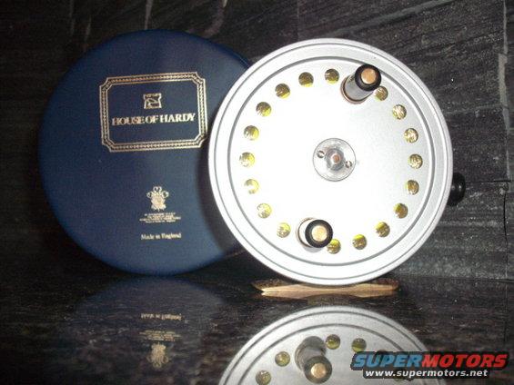 Silver fishing reel with blue House of Hardy case