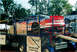 1971 Ford Ranchero - A race car with prominent "Ford Credit" sponsorship is loaded onto a trailer, likely for transport to or from a racing event.