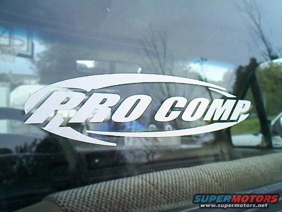 White Pro Comp sticker on the inside of a vehicle window. Supermotors.net logo visible at bottom right