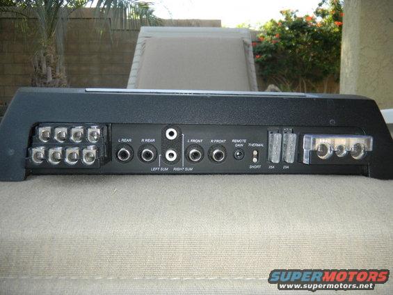 Black car amplifier with labeled input and output terminals