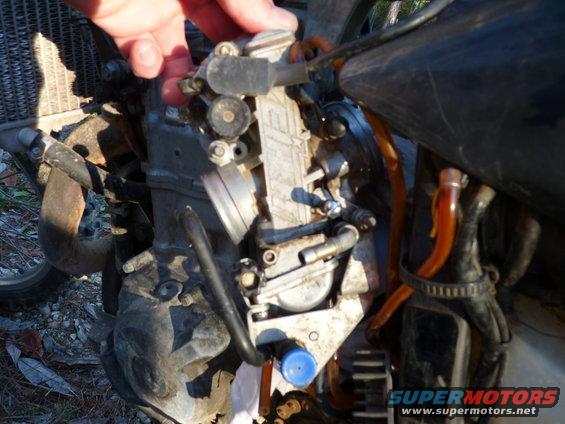 Motorcycle carburetor with fuel lines and engine components