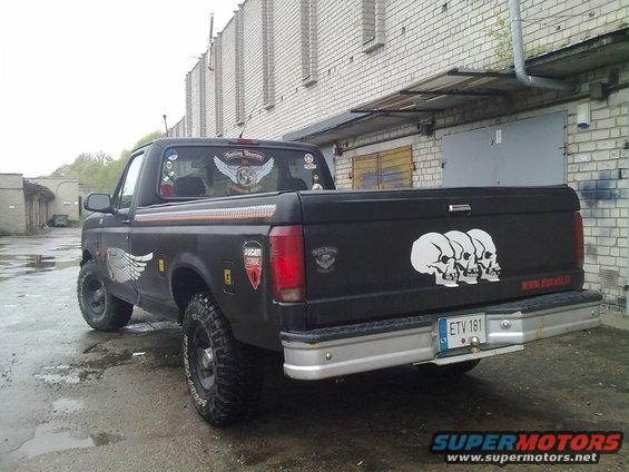 Black pickup truck with skull decals on the tailgate and wing decals on the side and rear window. License plate is ETV 181