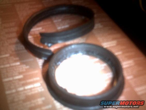 Two rubber seal rings on a patterned surface, one is broken