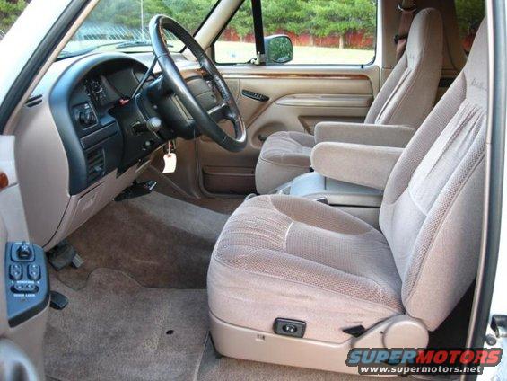 Interior shot of a truck or SUV, showing front seats, dashboard, and steering wheel