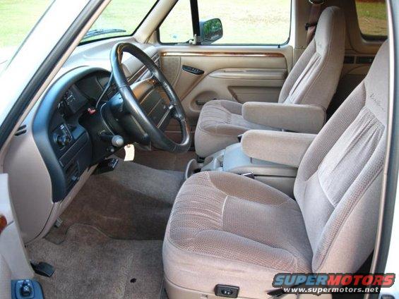 1996 Ford Bronco interior with tan cloth seats, dashboard, and steering wheel