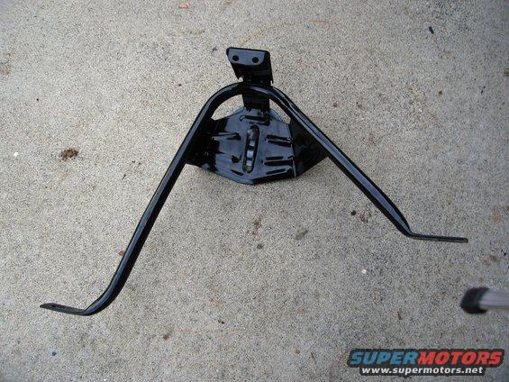 Black metal tire carrier bracket on concrete