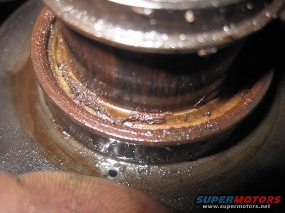 Worn bearing seal with debris and grease