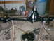 1995 Ford Bronco - A differential axle assembly is shown disassembled and supported by stands in a workshop.