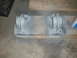 1995 Ford Bronco - Two metal brackets painted gray and mounted on a wooden plank.