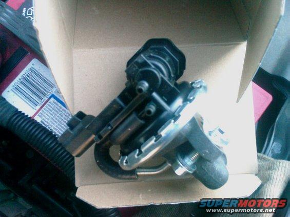 EGR valve assembly in a cardboard box, with a label visible on the left