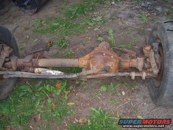 Rusty front axle assembly with tires