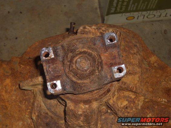 rusted differential housing with four bolt holes