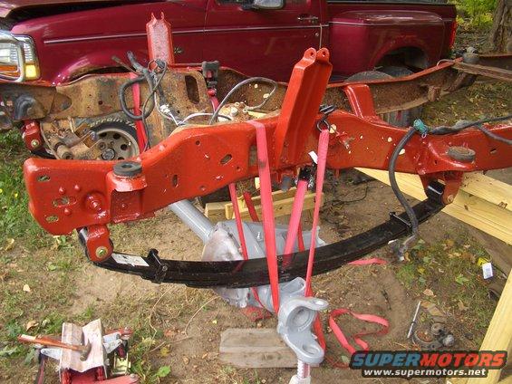 Red 1992 Ford F-150 truck frame with red suspension components
