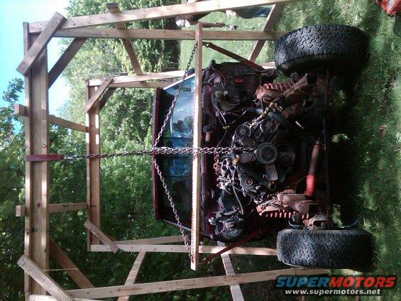 Truck engine and chassis suspended in wooden frame
