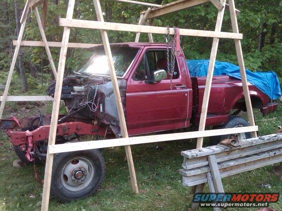 1992 Ford F-150 pickup truck with front end removed, supported by wooden frame