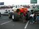 1994 Ford Bronco - A custom-built monster truck with oversized tires and bright orange accents sits on display.