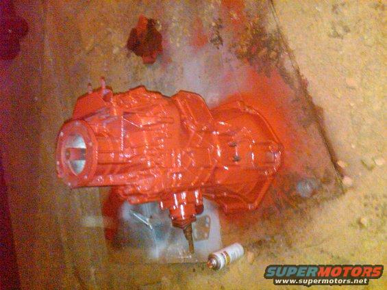 red painted transmission with spray can nearby