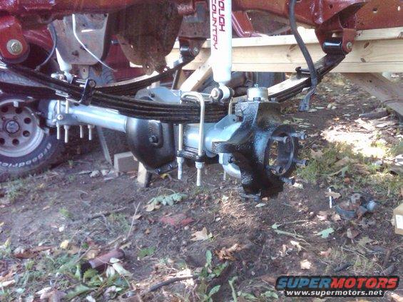 truck rear axle with leaf springs and shock absorber
