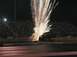1994 Ford Bronco - A monster truck performs a stunt with pyrotechnics during a nighttime event at a stadium.