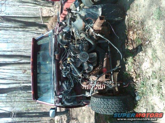 Maroon 1992 Ford F-150 engine bay with exposed engine components and front tire