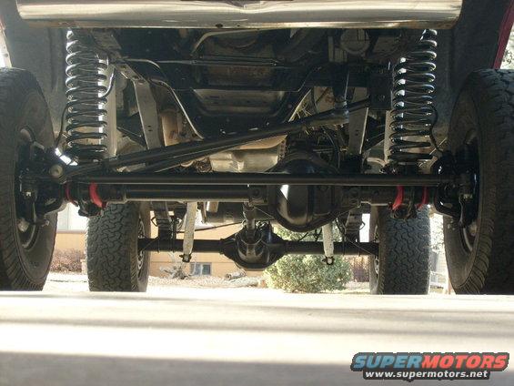 Underbody view of a 1986 Ford Bronco showing suspension and drivetrain components