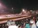 1994 Ford Bronco - A truck performs a burnout during a drag race event at night, with a large crowd watching from the stands.