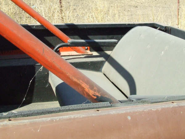 Interior view of a vehicle with a roll bar and a light-colored seat