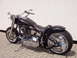 1972 Ford Ranchero - A black custom motorcycle with chrome details is viewed from the side against a white wall.