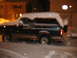 1995 Ford Bronco - A Ford Bronco is parked outside during a snowstorm at night.